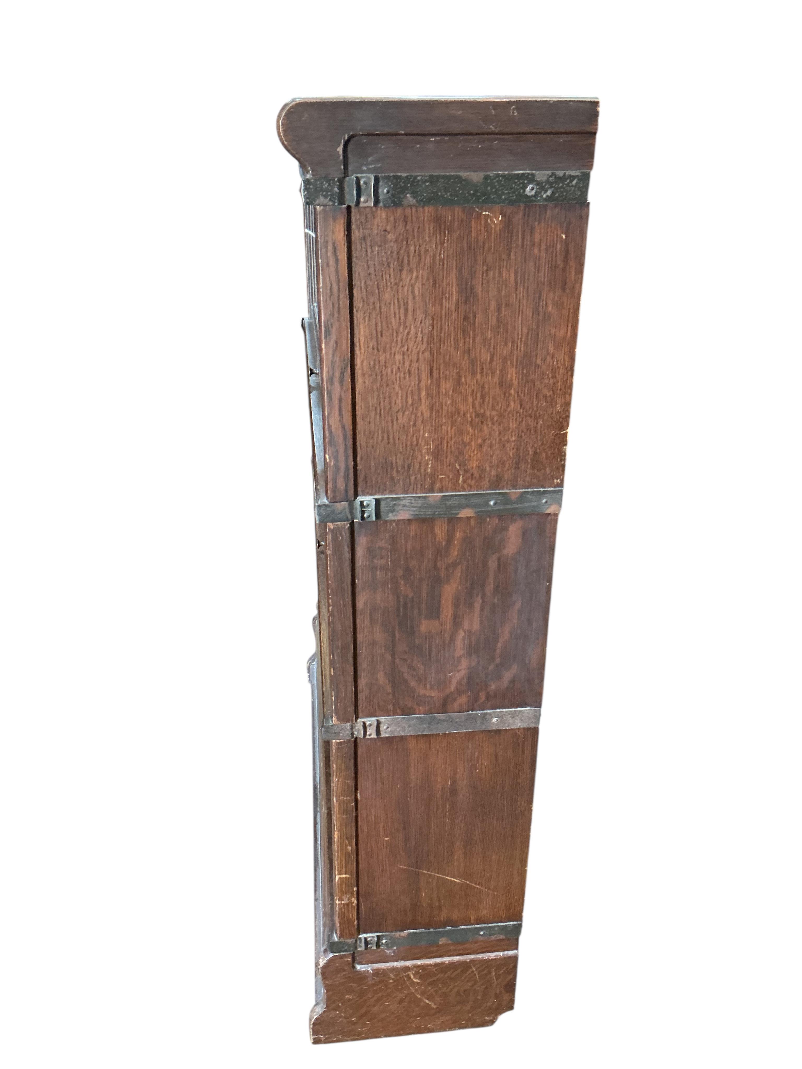A Globe Wernicke style oak three section bookcase, width 86cm, depth 27cm, height 115cm
